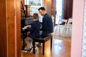 a child playing the piano during his lesson in LA