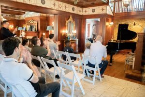 people cheering on a child as he finishes his piano recital