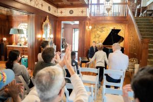 people cheering on a child as he finishes his piano recital 2